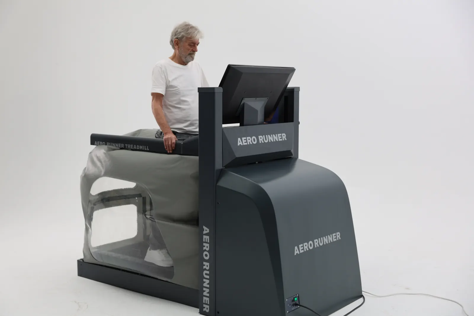 An older patient training on the AERO RUNNER, seen from the drive unit side